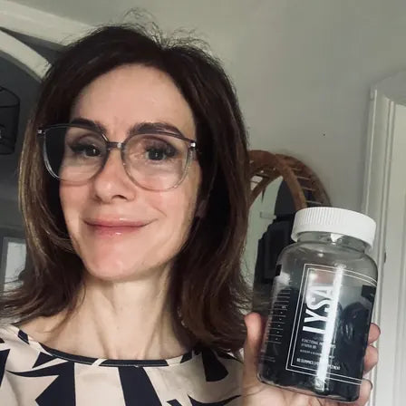 Hayley holding a jar of Lysa Wellness gummies
