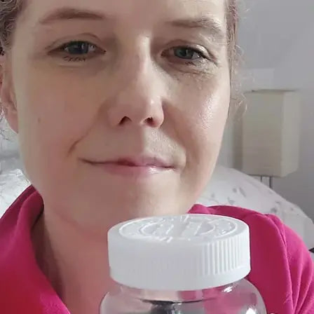 Jackie holding a jar of Lysa Wellness gummies