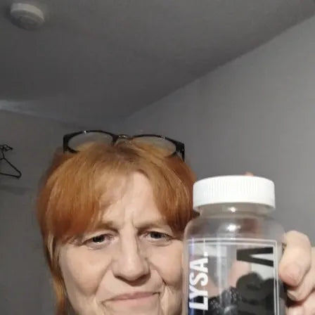 Jacqui holding a jar of Lysa Wellness gummies